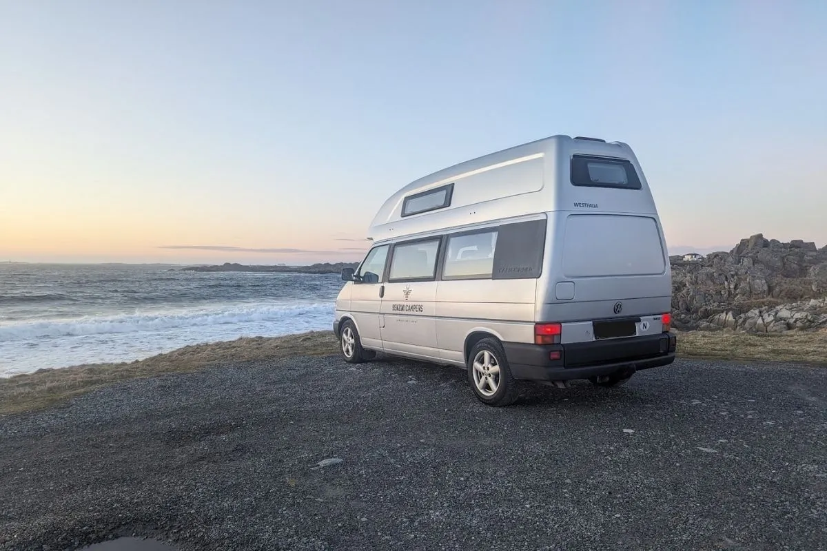 campervan parked by sea in southern Norway under April sunset sky