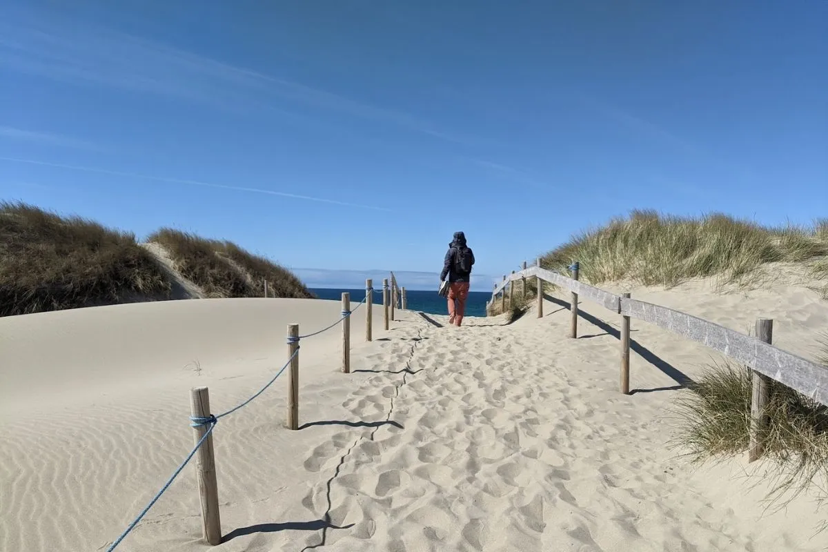 walking on a Borestranda beach dunes in southern Norway in April sun